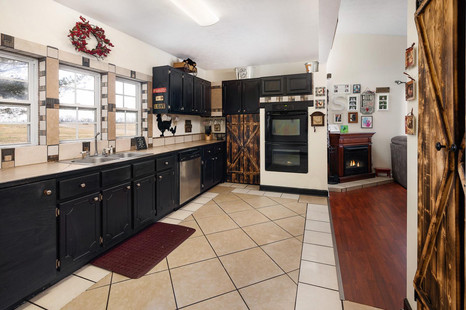 2958 Kinneys Road Cedar Hill, TN 37032 - Photo 17 of 30 a kitchen with stainless steel appliances granite countertop a refrigerator and a sink