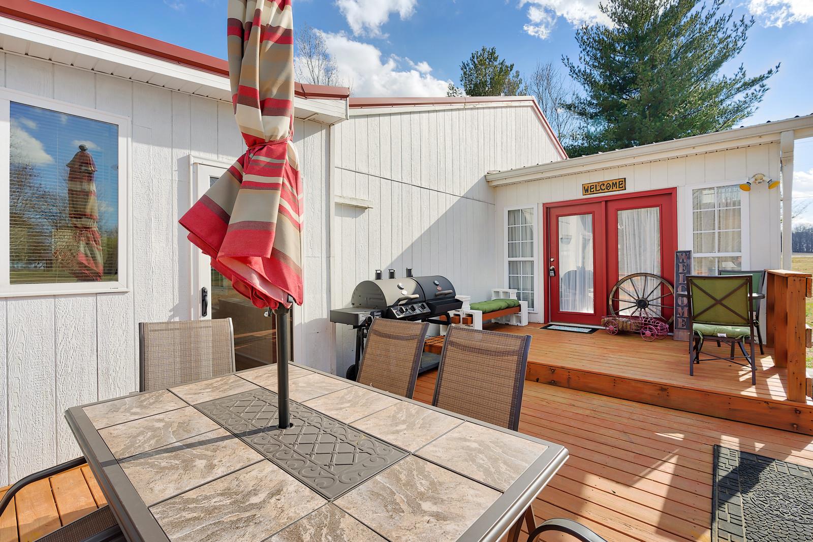 2958 Kinneys Road Cedar Hill, TN 37032 - Photo 3 of 30 a view of a patio with dining table and chairs with wooden floor and fence