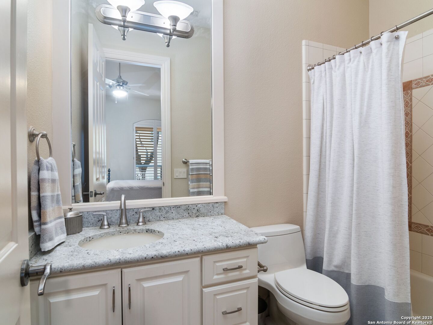 31 Stratton Lane San Antonio, TX 78257 - Photo 21 of 42 a bathroom with a granite countertop sink toilet and mirror