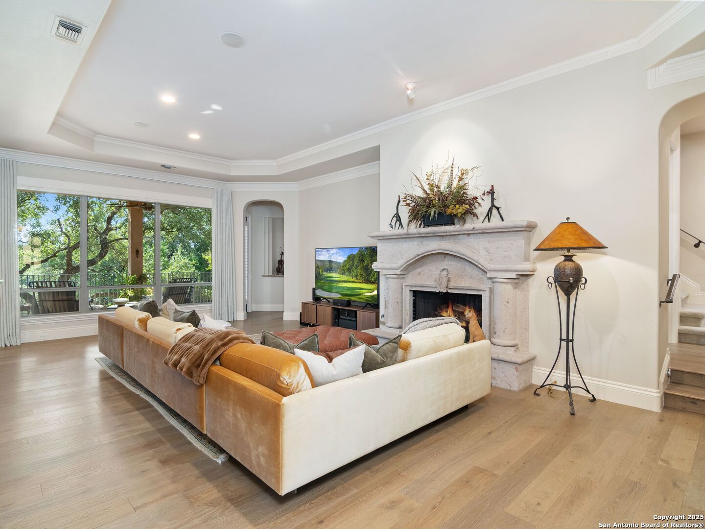 31 Stratton Lane San Antonio, TX 78257 - Photo 6 of 42 a living room with furniture a fireplace and a floor to ceiling window