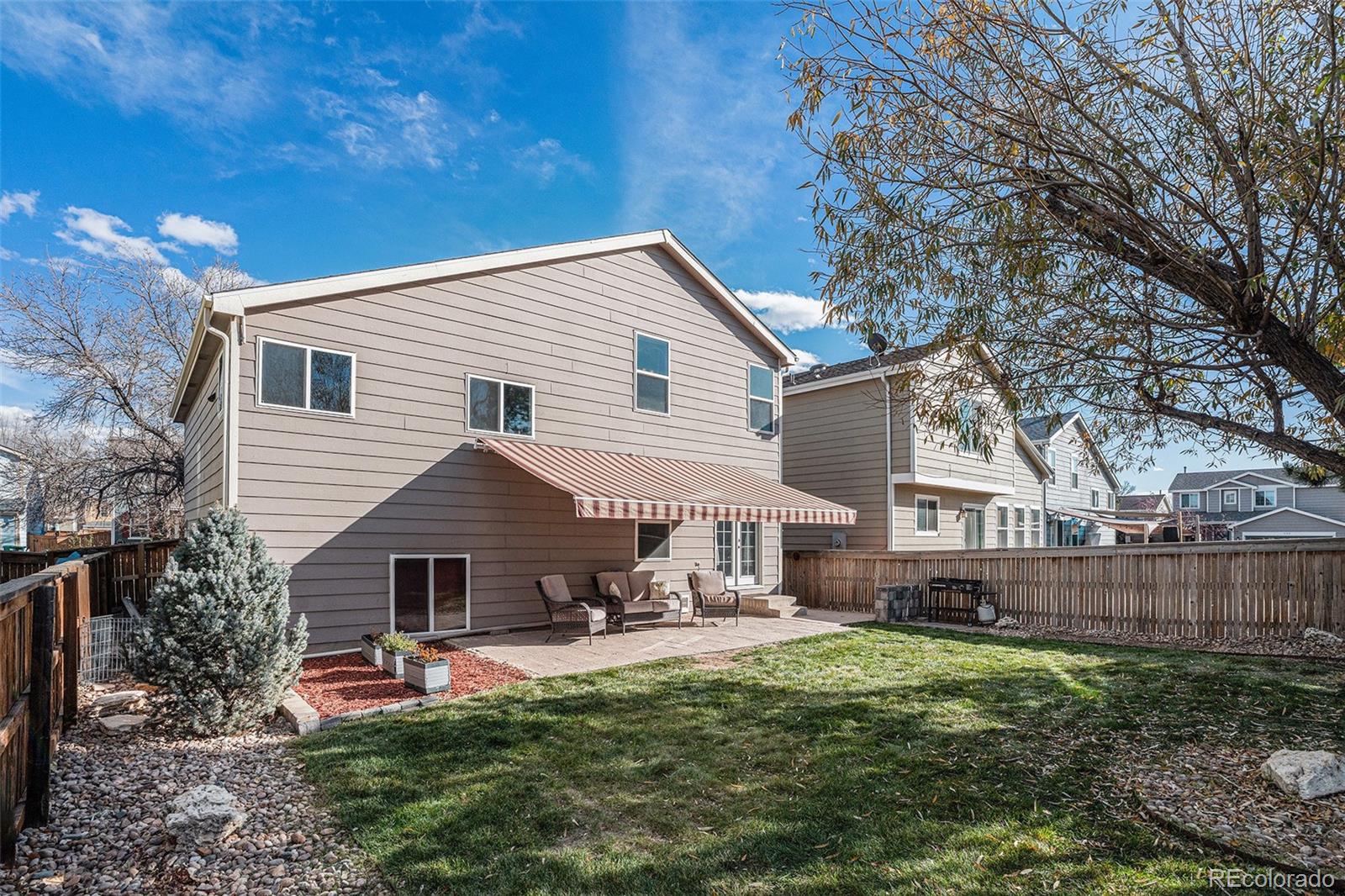 1085 Mockingbird Street Brighton, CO 80601 - Photo 15 of 21 a front view of a house with a yard and outdoor seating