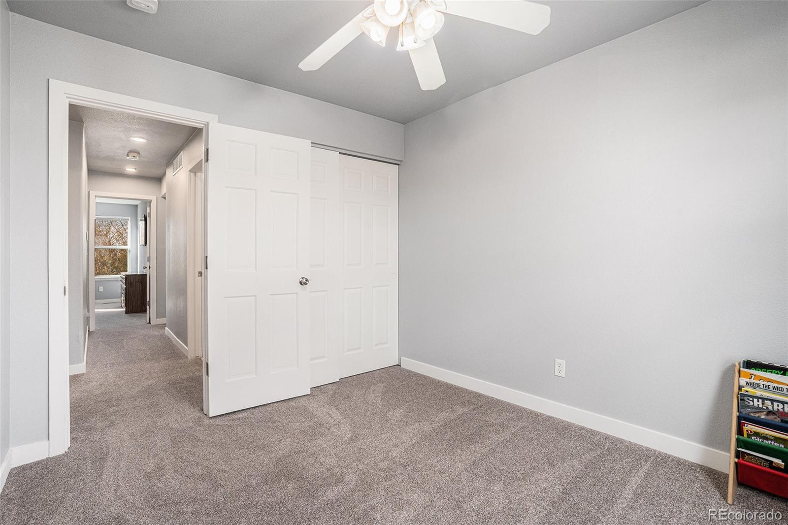 1085 Mockingbird Street Brighton, CO 80601 - Photo 18 of 21 an empty room with a mirror and a view of bathroom
