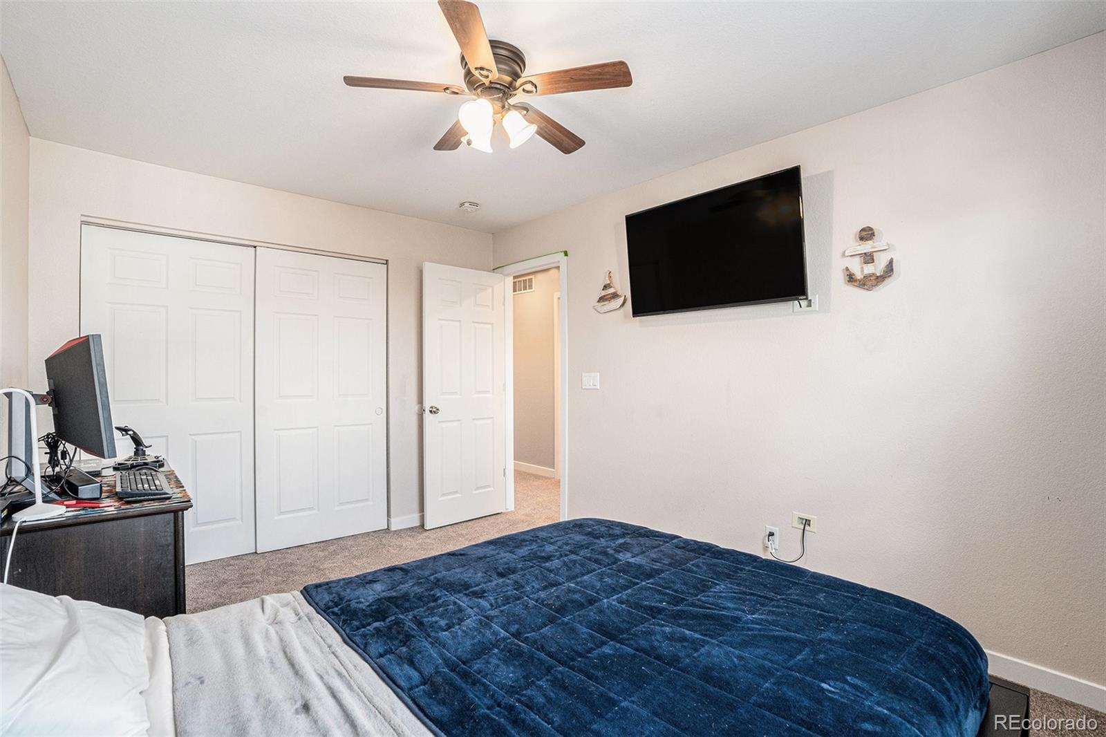 1085 Mockingbird Street Brighton, CO 80601 - Photo 19 of 21 a bedroom with a bed and a flat screen tv