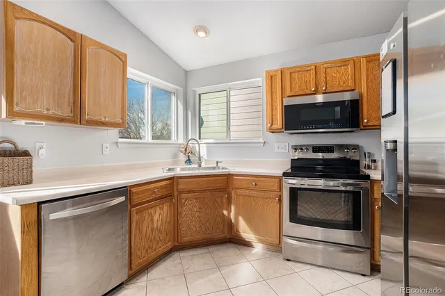 a kitchen with stainless steel appliances granite countertop a stove microwave and sink