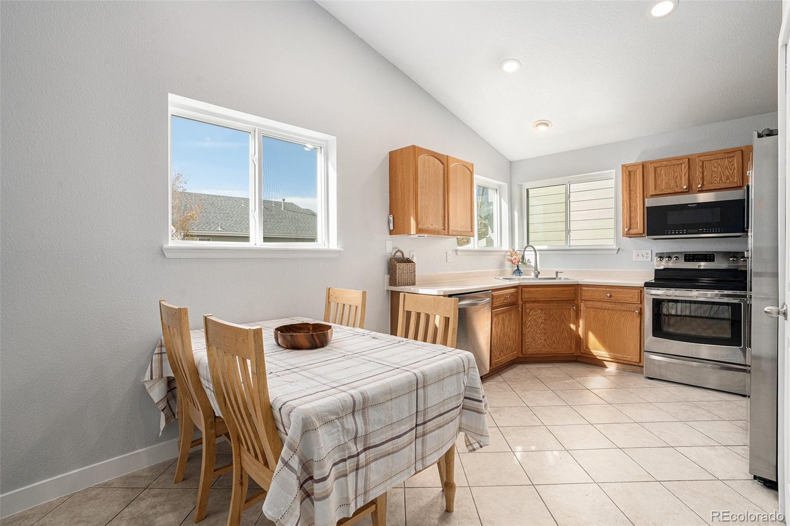 1085 Mockingbird Street Brighton, CO 80601 - Photo 4 of 21 a kitchen with a stove a sink and a microwave