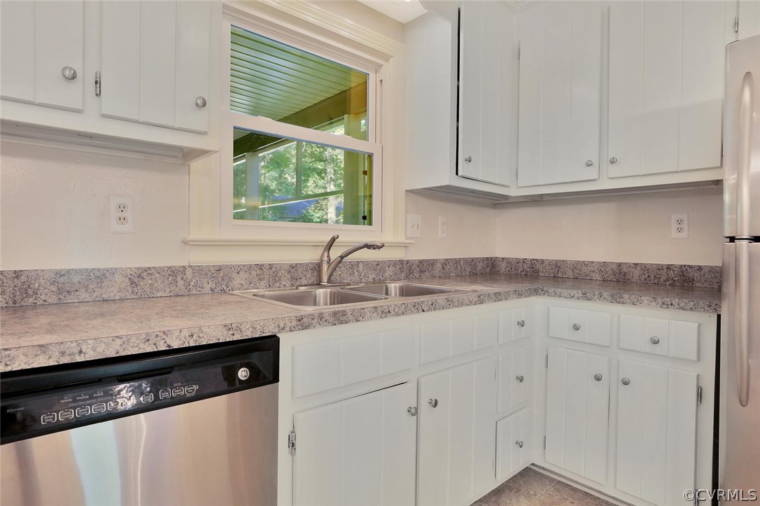 1930 Esquire Road North Chesterfield, VA 23235 - Photo 9 of 26 a kitchen with granite countertop white cabinets and a sink