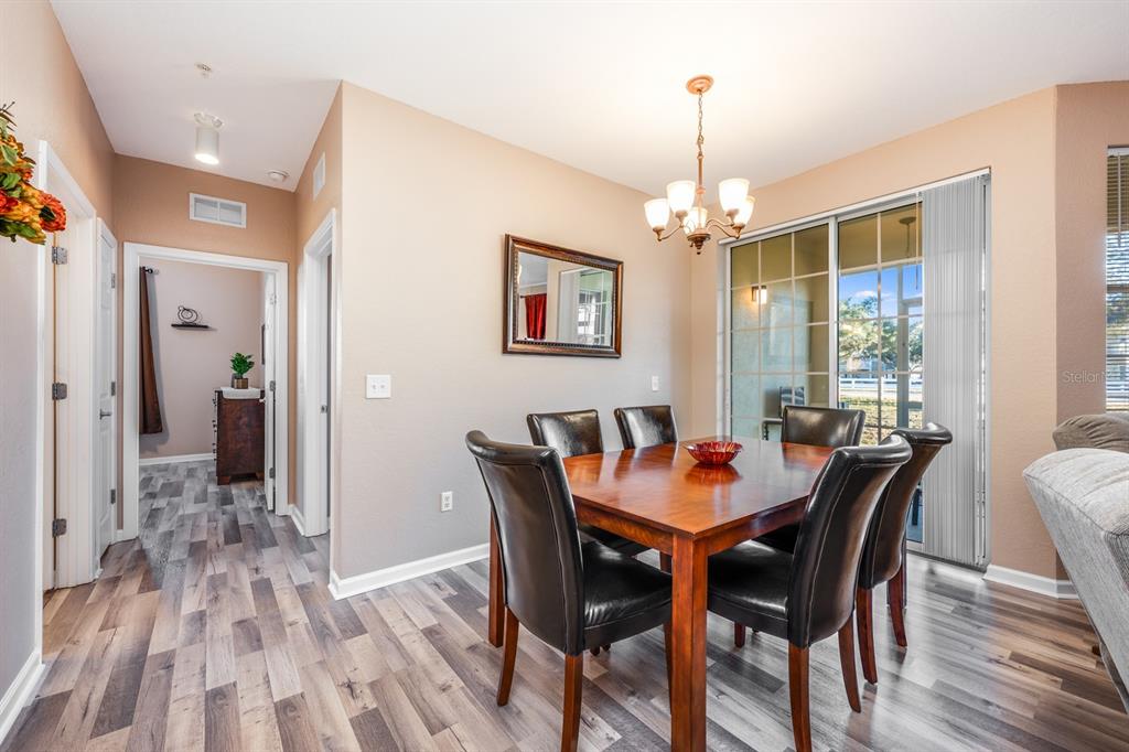 102 Terrace Ridge Circle, Unit 102 Davenport, FL 33896 - Photo 11 of 32 a dining room with furniture window wooden floor