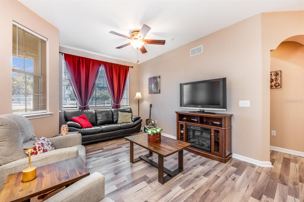 102 Terrace Ridge Circle, Unit 102 Davenport, FL 33896 - Photo 13 of 32 a living room with furniture and a flat screen tv