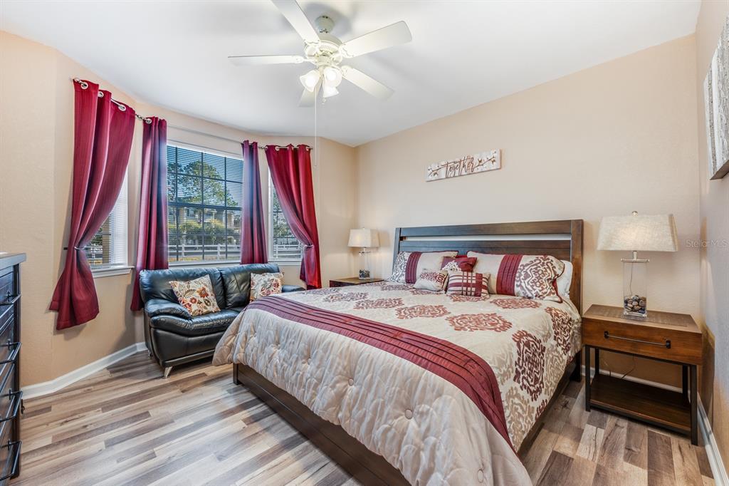 102 Terrace Ridge Circle, Unit 102 Davenport, FL 33896 - Photo 14 of 32 a bedroom with a bed and a chandelier