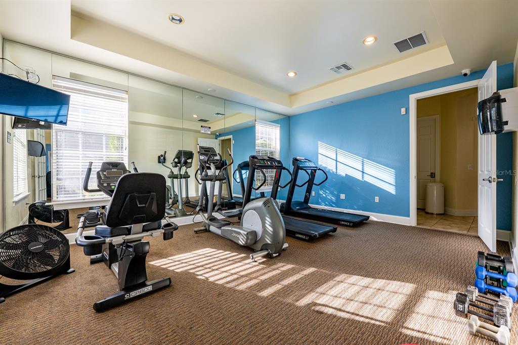 102 Terrace Ridge Circle, Unit 102 Davenport, FL 33896 - Photo 31 of 32 a view of a room with gym equipment