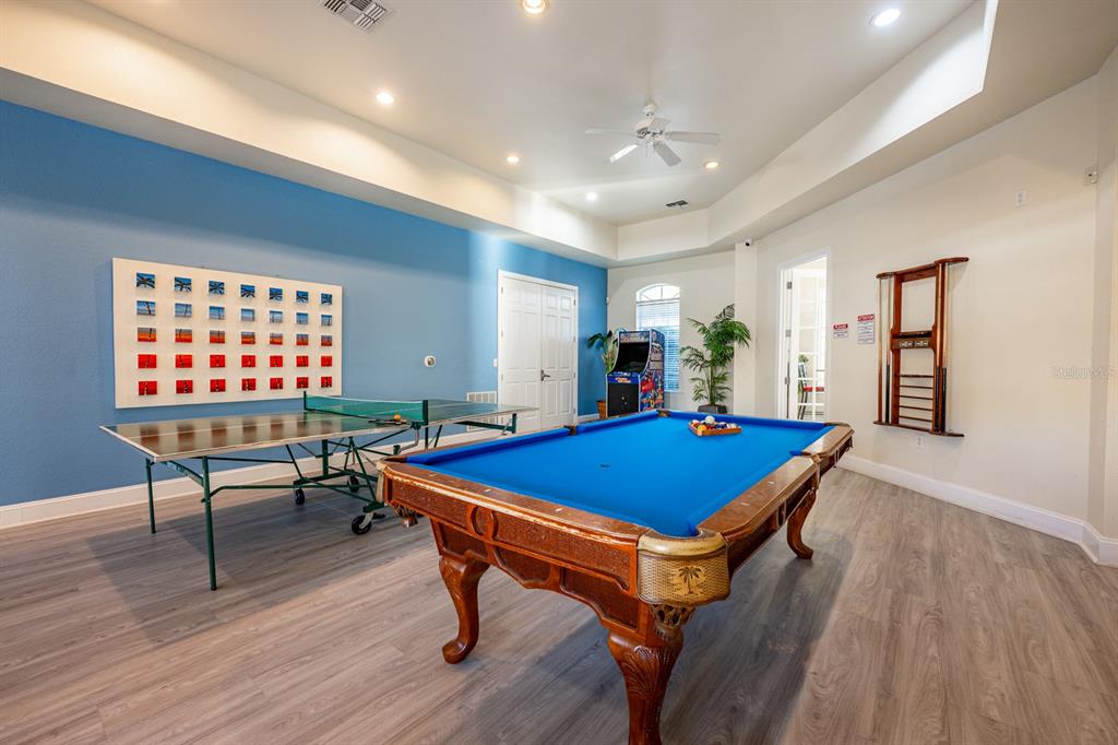 102 Terrace Ridge Circle, Unit 102 Davenport, FL 33896 - Photo 32 of 32 a room with furniture pool table and wooden floor
