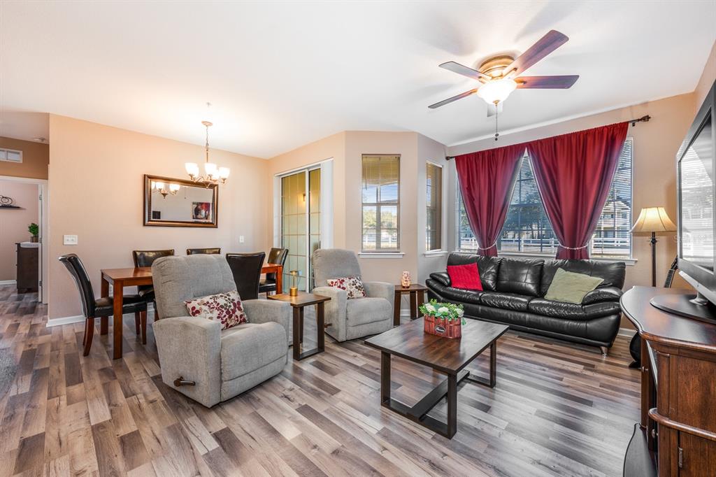 102 Terrace Ridge Circle, Unit 102 Davenport, FL 33896 - Photo 6 of 32 a living room with furniture a window and a flat screen tv