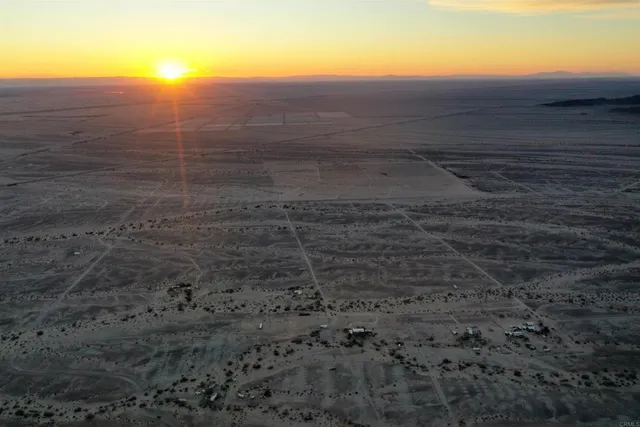 a view of mountain with a field