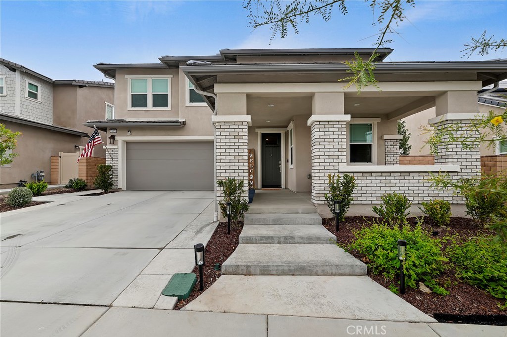 39526 Verbena Way Temecula, CA 92591 - Photo 11 of 55 a front view of a house with garage