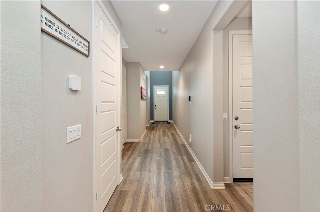 39526 Verbena Way Temecula, CA 92591 - Photo 17 of 55 a view of a hallway with wooden floor and staircase