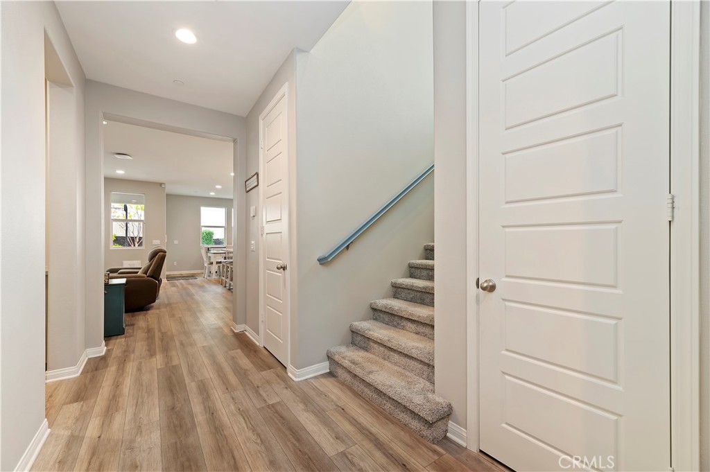 39526 Verbena Way Temecula, CA 92591 - Photo 18 of 55 a view of a hallway with wooden floor fireplace and living room