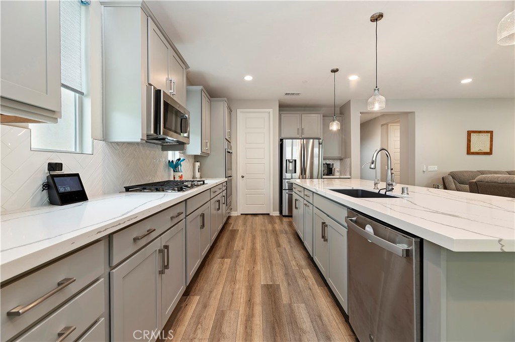 39526 Verbena Way Temecula, CA 92591 - Photo 21 of 55 a large kitchen with stainless steel appliances lots of counter space sink and cabinets