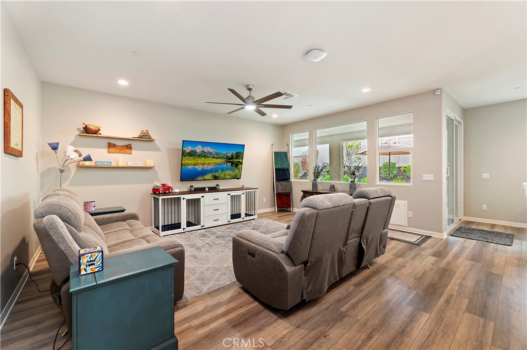 39526 Verbena Way Temecula, CA 92591 - Photo 23 of 55 a living room with furniture and a flat screen tv with wooden floor