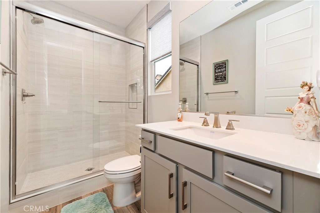 39526 Verbena Way Temecula, CA 92591 - Photo 27 of 55 a bathroom with a sink a toilet and shower