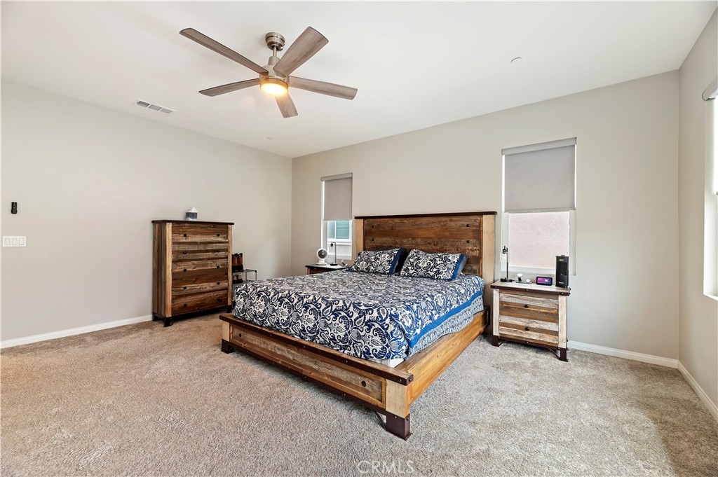 39526 Verbena Way Temecula, CA 92591 - Photo 32 of 55 a bedroom with a bed and a ceiling fan