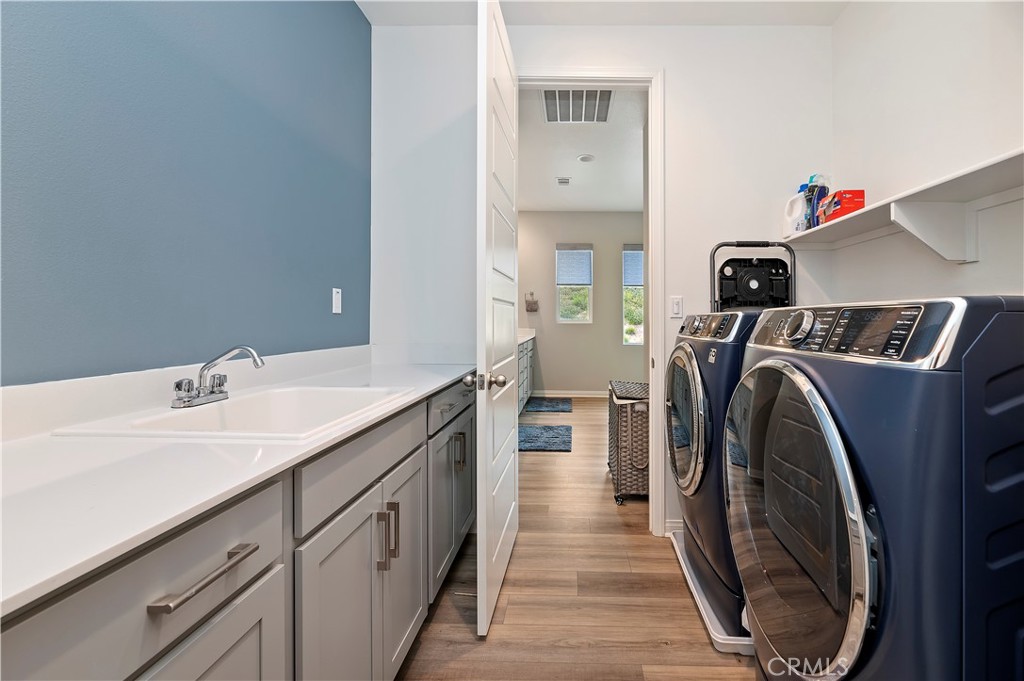 39526 Verbena Way Temecula, CA 92591 - Photo 36 of 55 a utility room with sink dryer and washer