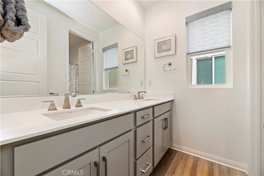 39526 Verbena Way Temecula, CA 92591 - Photo 39 of 55 a bathroom with a double vanity sink and a mirror
