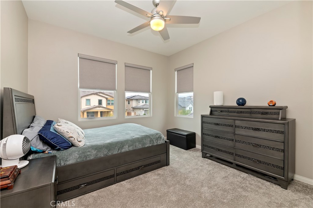 39526 Verbena Way Temecula, CA 92591 - Photo 40 of 55 a bedroom with a bed and a chandelier