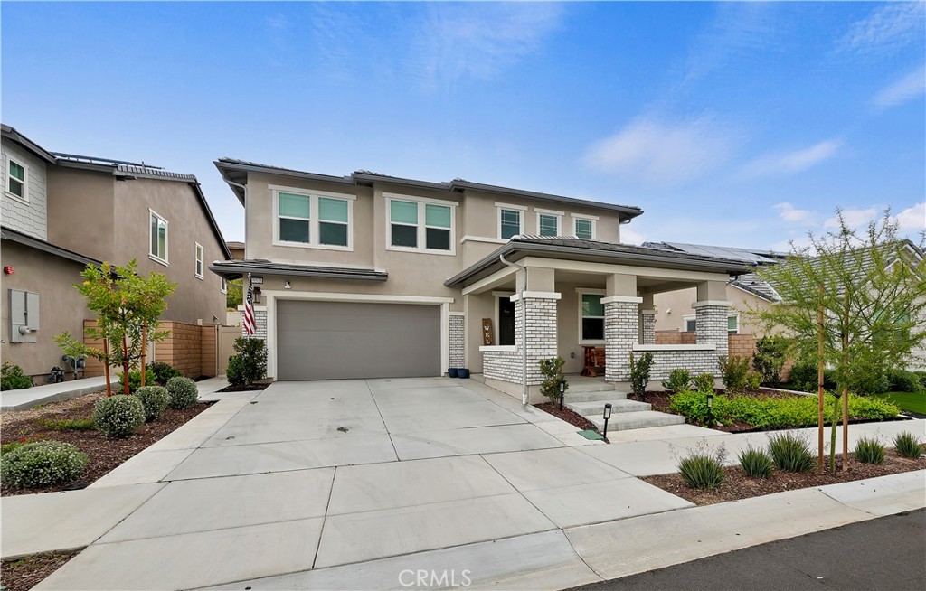 39526 Verbena Way Temecula, CA 92591 - Photo 10 of 55 a front view of a house with a garden
