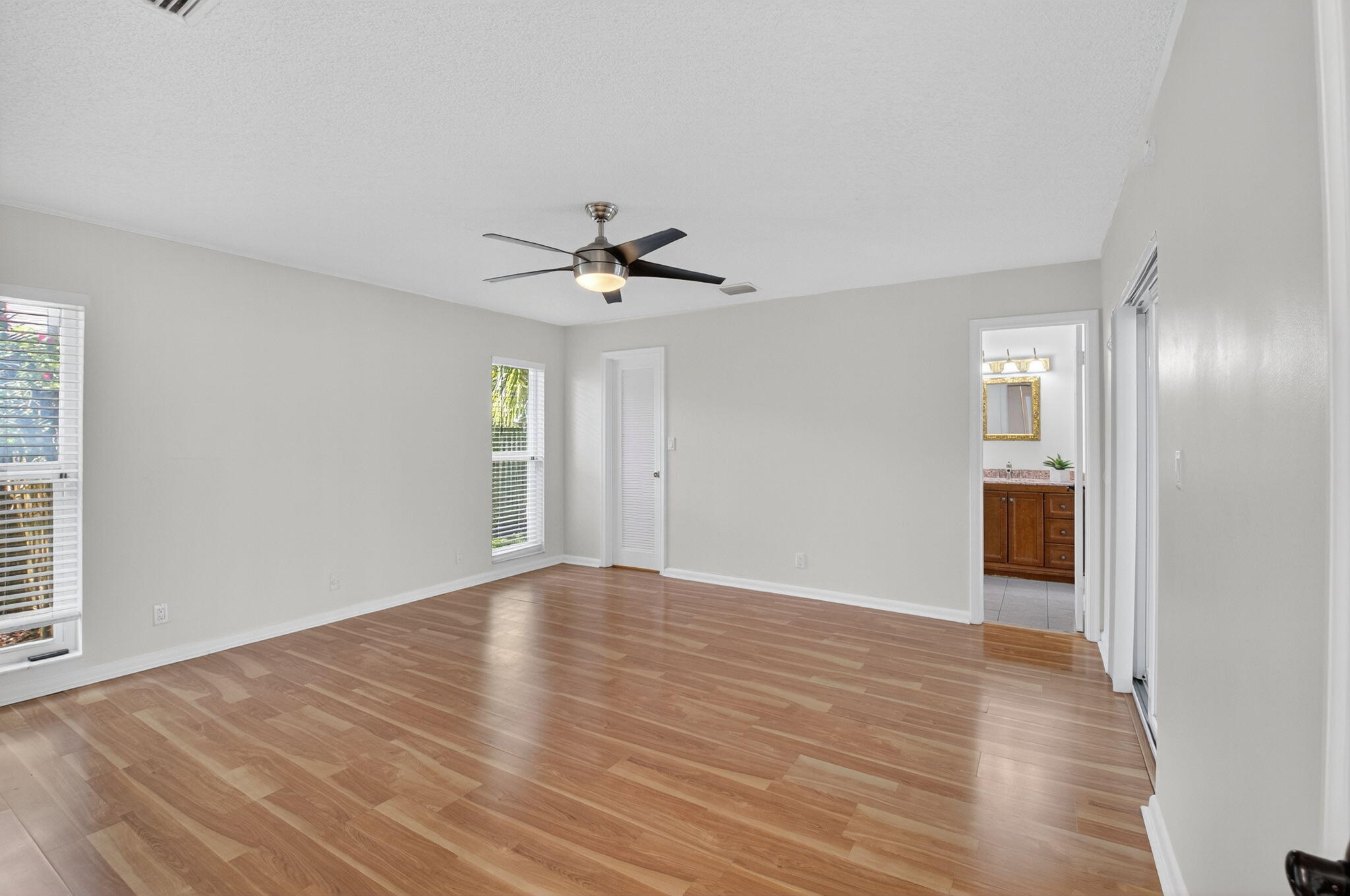 17414 Springtree Lane Boca Raton, FL 33487 - Photo 25 of 49 a view of an empty room with wooden floor