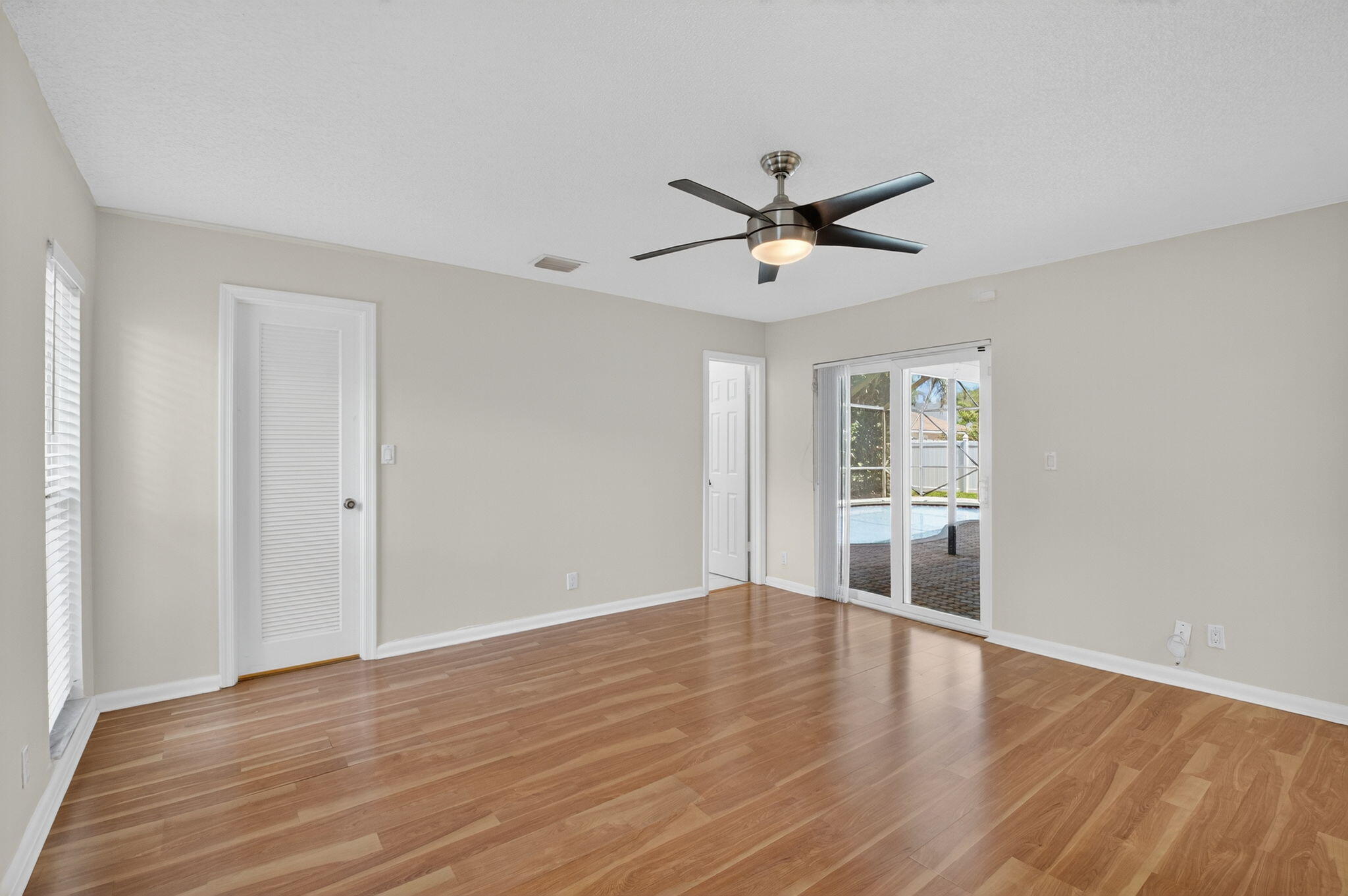 17414 Springtree Lane Boca Raton, FL 33487 - Photo 26 of 49 a view of empty room with wooden floor and fan