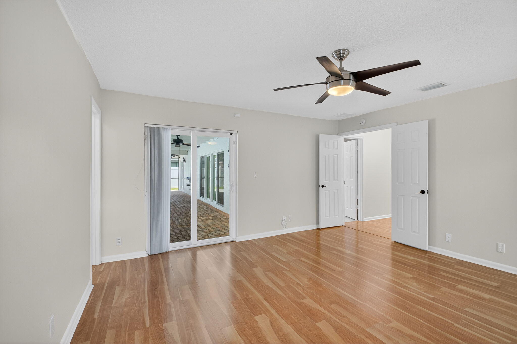 17414 Springtree Lane Boca Raton, FL 33487 - Photo 27 of 49 a view of empty room with wooden floor and fan