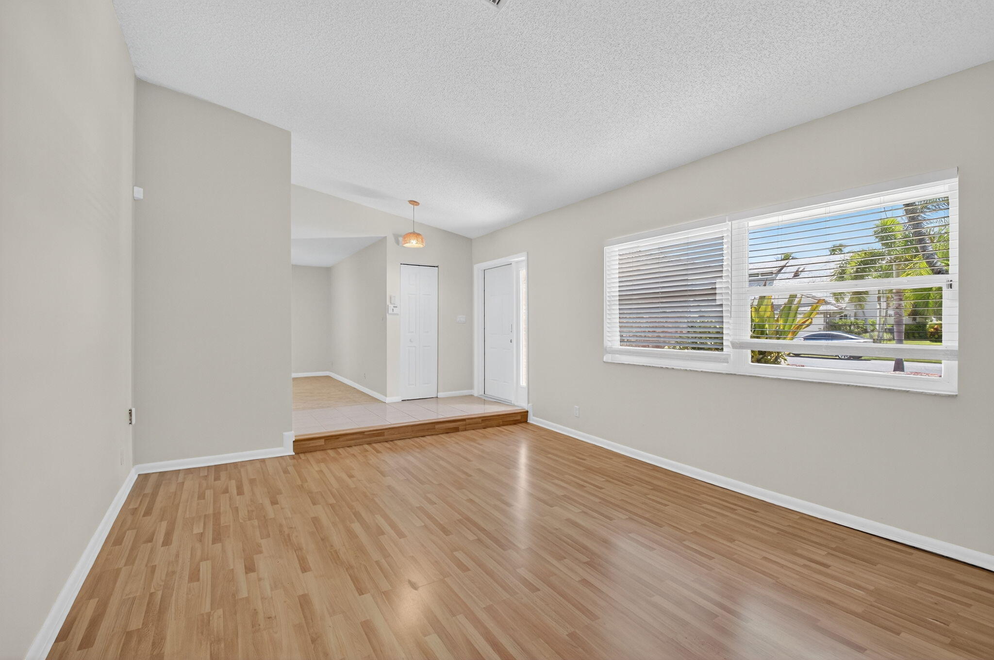17414 Springtree Lane Boca Raton, FL 33487 - Photo 9 of 49 a view of empty room with wooden floor and fan