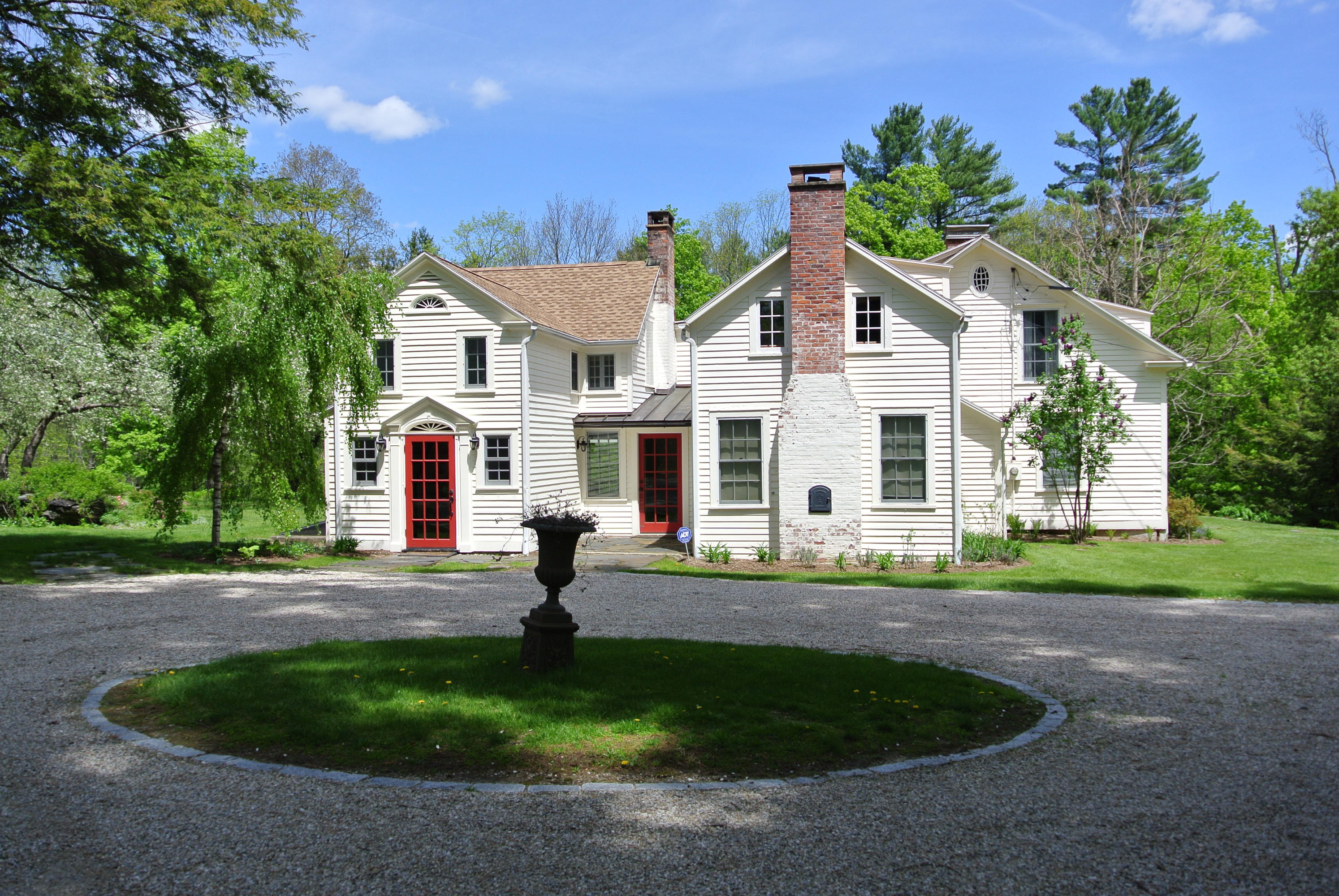 1 Interlaken Road Stockbridge, MA 01262 - Photo 3 of 27 a front view of a house with a yard and garage