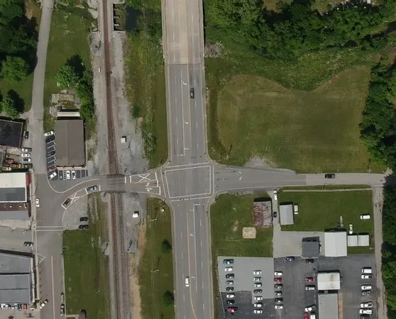 an aerial view of a residential houses with outdoor space and parking
