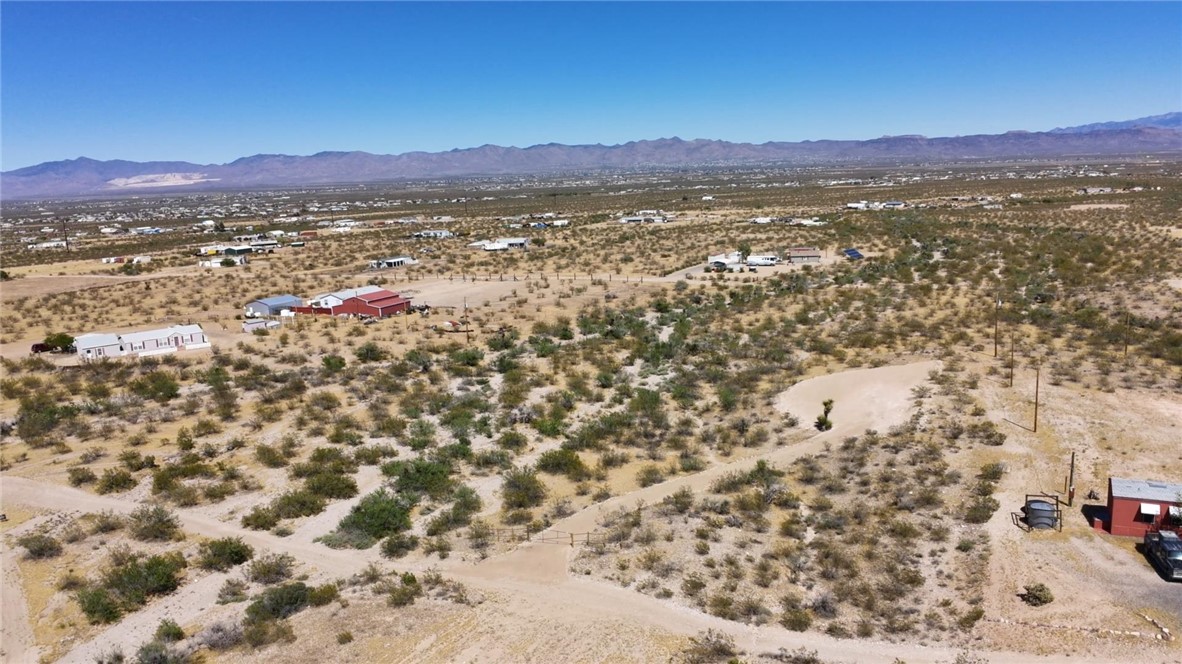 1386 Don Luis Road Golden Valley, AZ 86413 - Photo 35 of 47 Expansive desert landscape with scattered vegetation, offering a remote setting with distant mountains under a clear sky