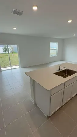a kitchen with a cabinets and white stove top oven