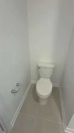 a white toilet sitting next to a white sink