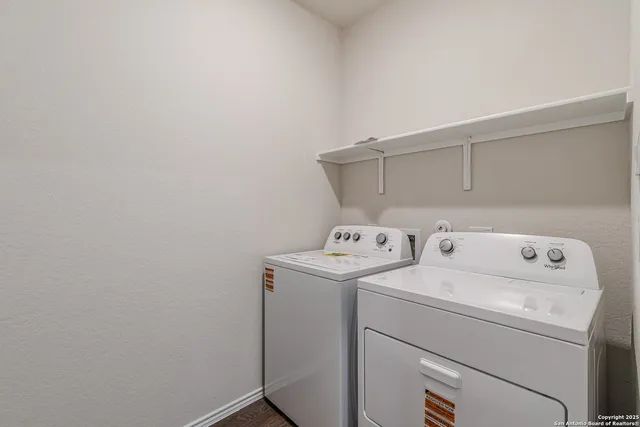 a kitchen with kitchen island granite countertop a sink appliances and cabinets
