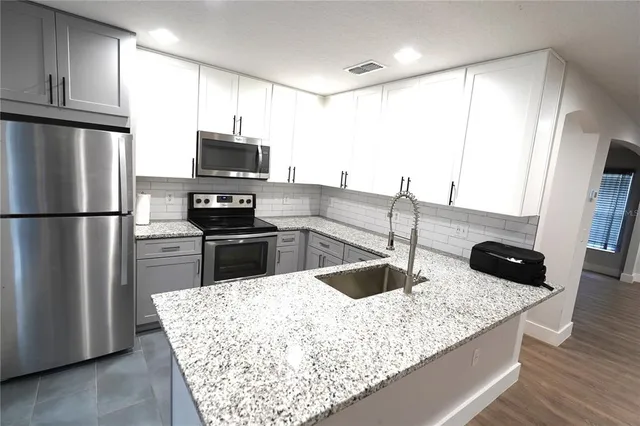 a kitchen with a refrigerator sink and stove