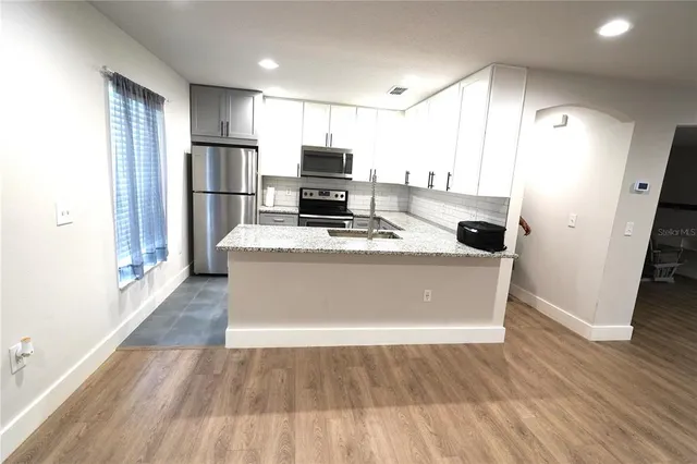a view of kitchen with wooden floor