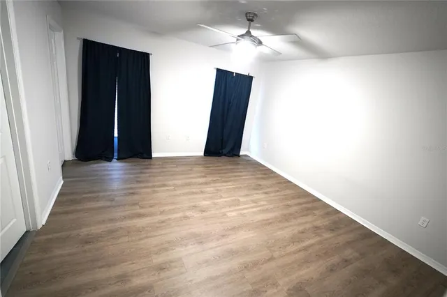a view of hallway with wooden floor