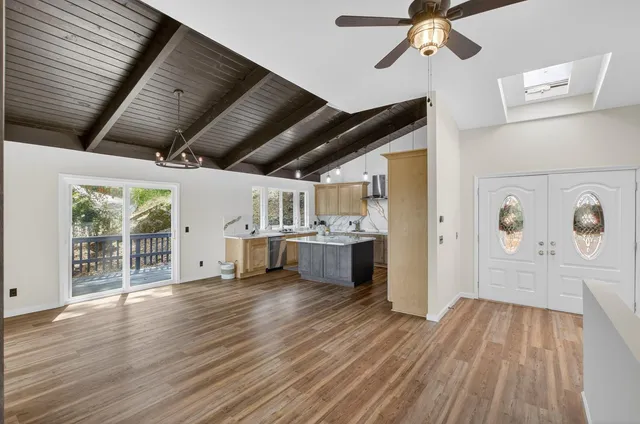 a large kitchen with a sink and cabinets