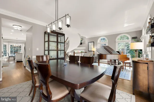 a dining room with furniture and wooden floor
