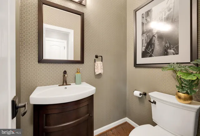 a bathroom with a toilet a sink and mirror