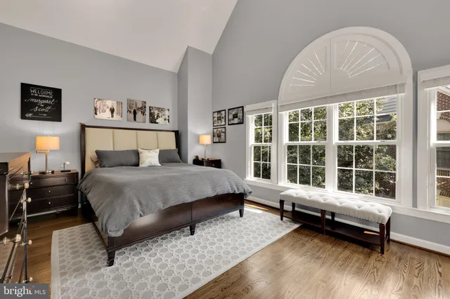 a spacious bedroom with a bed and a large window