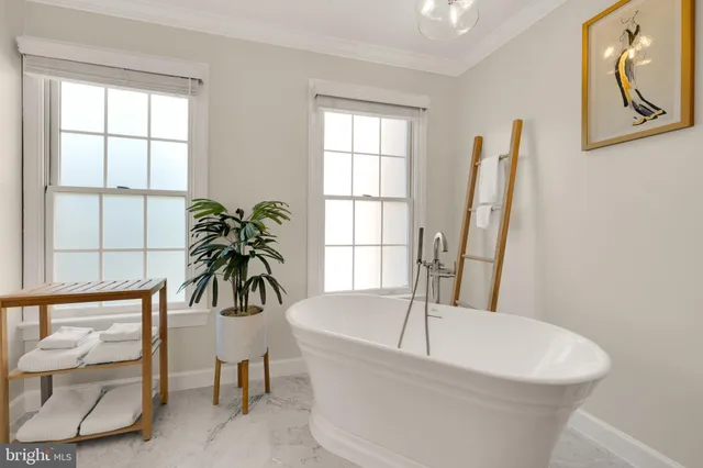 a white bath tub sitting next to a window