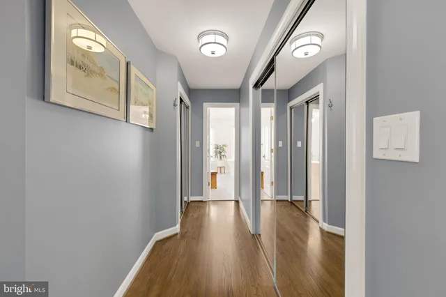 a view of hallway with wooden floor