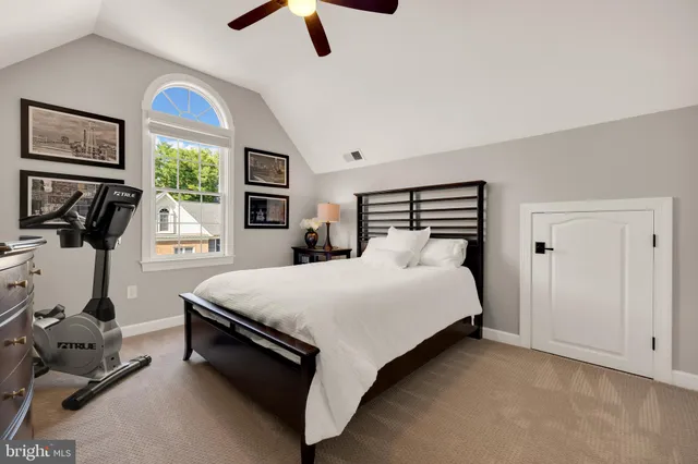 a bedroom with a bed a window and gym equipment