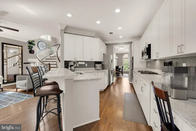 a large kitchen with stainless steel appliances lots of counter space and windows