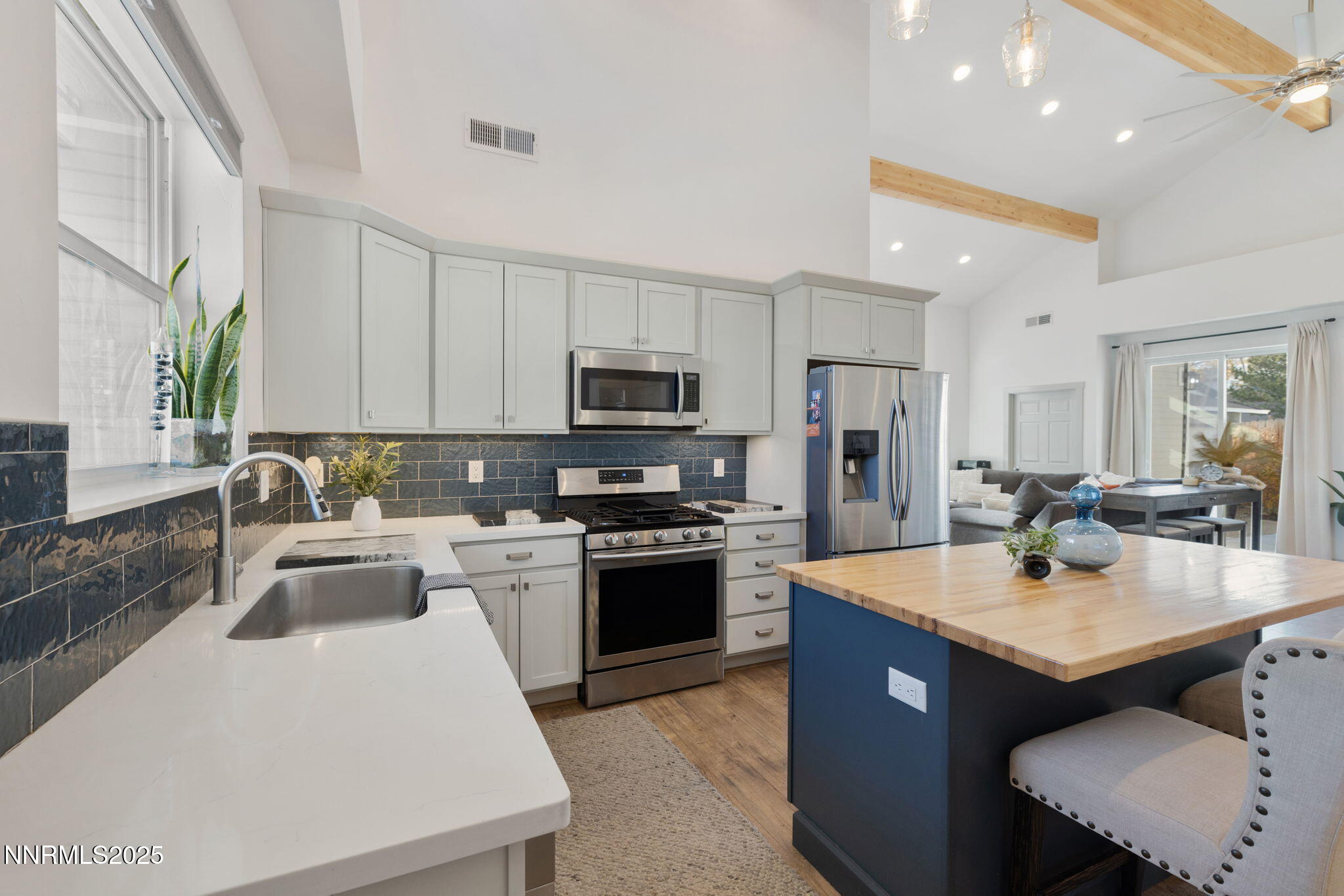 1217 Lander Street Reno, NV 89509 - Photo 3 of 20 a kitchen with a sink stove and microwave